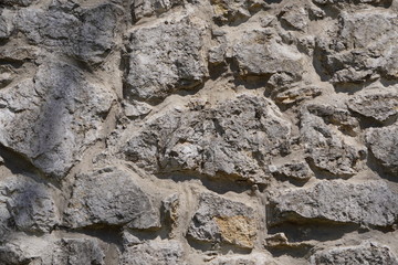 Stone wall, large gray stones, civil and industrial construction.