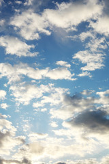 Beautiful blue sky with whipped white clouds that are illuminated by the sun