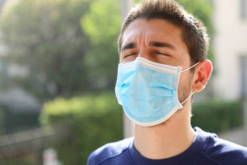 COVID-19 Pandemic Coronavirus Close up of man with surgical mask breathing outdoor