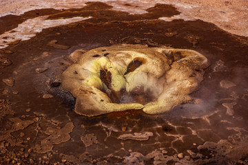 Beautiful colourful Icelandic landscape lava fields mountain geysers zigzag road and moss-covered stones Namafjall, Iceland.