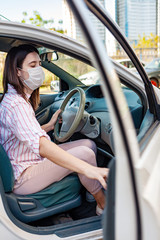 Young woman  in protective medical mask driving a car. Person in a mask. Safety during coronavirus pandemic, epidemic covid-19.
