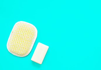 Rest and relaxation, organic cosmetics for body care - washcloth and natural handmade soap, bath accessories, ready to use. Zero waste bath care concept. Flat lay, blue background with copy space.
