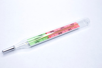 Medical mercury glass thermometer for measuring human body temperature. Isolated on a white background.