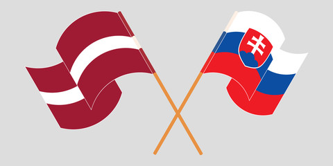 Crossed and waving flags of Slovakia and Latvia