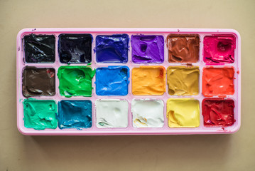 Gouache paint palette, pink on neutral background