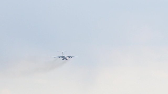 A white plane with signal lights lit, flies directly to the camera in beautiful sky. landing gear is released, aircraft is on the approach to its destination and ready to land. Large passenger plane