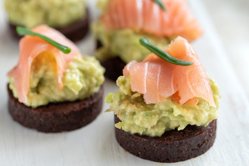 Avocado paste with salmon on wholemeal bread