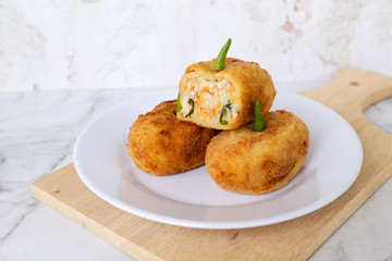 Croquettes potato filled with chili on a white plate. Asian cake cuisine dish for meal