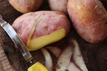Red potatoes on a wooden table macro