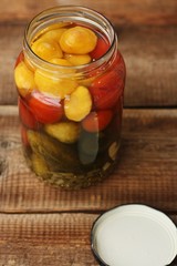 Salted tomatoes cucumbers and squash in a jar 