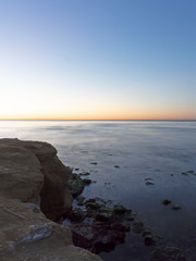 Calm ocean as the sun sets on a clear day