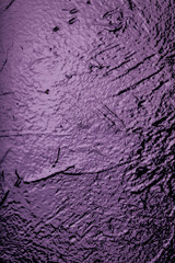 Purple shines on black wall background texture