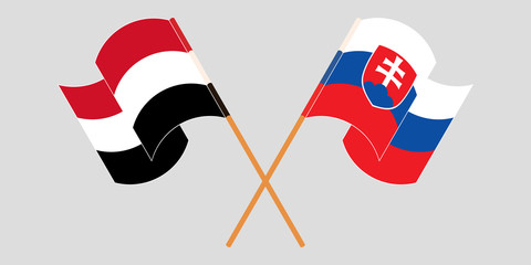 Crossed and waving flags of Slovakia and Yemen