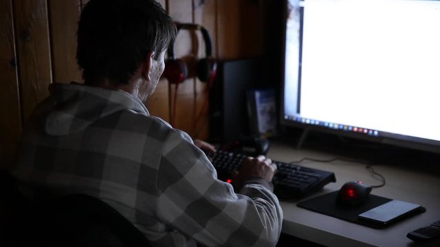 Programming concept. Man programmer working on computer at home coding on screen writing code. Programmer IT engineer working on project typing data codes