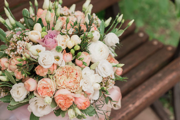 large flower arrangement in a big white hat box was created by a florist for a wedding gift. White Freesia ,  Ranunculus asiaticus, eustoma flowers, roses and eucalyptus in a flowers box