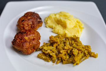 close up meatballs,mashed and green beans potatoes in plate