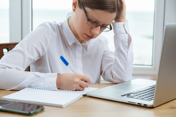 Woman working with computer, get sad thinking expression. Problem at work.