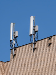 Fototapeta na wymiar Mobile communication antennas on the wall of a building