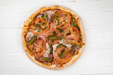 Italian pizza on white wooden background