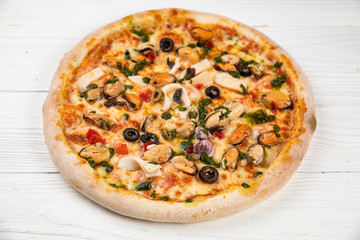 Italian pizza on white wooden background