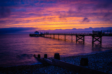Obraz premium Old pier in Totland Bay at the Isle of Wight by night, UK