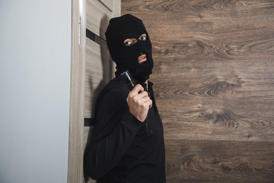 dangerous burglar sneaking into the house