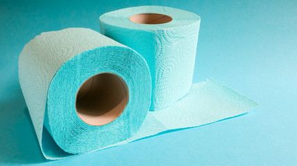 Blue roll of modern toilet paper on a blue background. A paper product on a cardboard sleeve, used for sanitary purposes from cellulose with cutouts for easy tearing. Embossed drawing