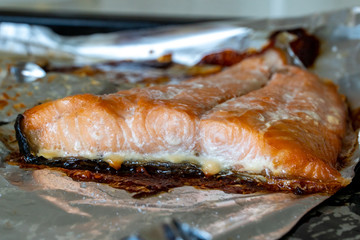 Baking at home. Trout baked in foil on an old baking sheet.