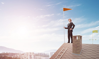 Young businessman with flag presenting concept of leadership. Mixed media