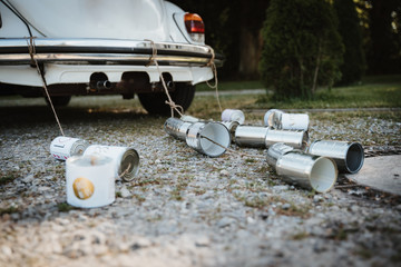 photo of cans behind a wedding car