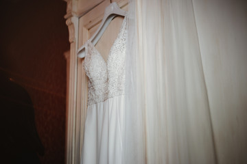 photo of a wedding dress hanged on a closet