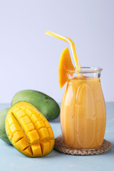 Homemade tropical smoothie of mango on a light background, horizontal format, Closeup