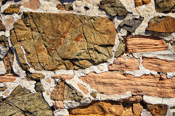 Large natural stone in a wall as a stone texture background.