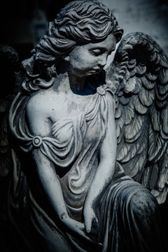 Retro styled image of ancient partially destroyed statue of beautiful angel.