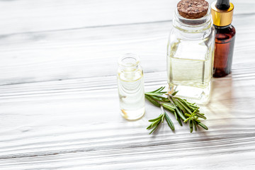 organic cosmetics with extracts of herbs rosemary on wooden background