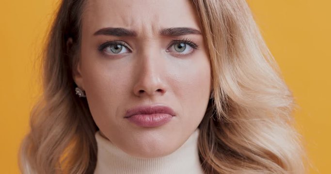 Shocked woman frowning face and shaking no on camera