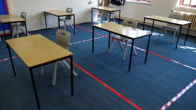 4K: Empty Classroom with Tape on the floor between desks for Social Distancing to prevent the spread of COVID-19 Coronavirus in Education. Crane Shot. Stock Video Clip Footage