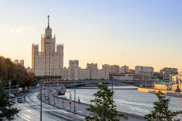 Fototapeta na wymiar View to Kotelnicheskaya Embankment Building from fFloating Bridge in Park Zaryad`ye. Moscow centre. Summer sunrise.