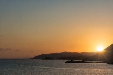 Fototapeta na wymiar Magnificent sunset over the sea and mountains. Travel invitation.