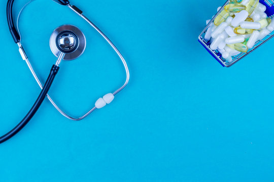 Pills And Stethoscope On Medical Desk Flat Lay Blue