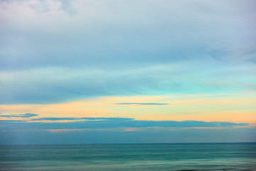 Fototapeta na wymiar Sea and cloudy sky at sunset