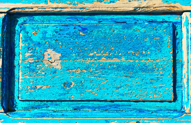 Wooden texture with frame and flaking old blue paint