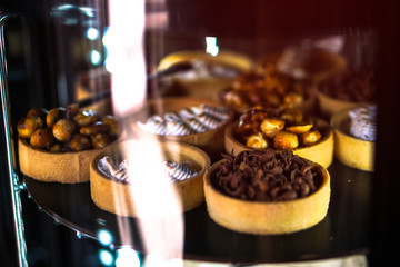 Delicious sweets in a shop window. Beautiful cookies for sale. Stock background