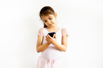 little caucasian girl looking at smartphone. Watching videos and social media. Online communication during COVID-19 pandemic quarantine concept.