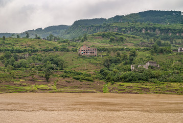 Fengdu, Chongqing, China - May 8, 2010: Yangtze River. Green hilly shoreline with agriculture plots...