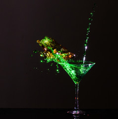 Colorful cocktail being splashed into martini glass