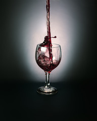 red wine pouring into glass