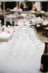 photo of champagne glasses pyramid on a table