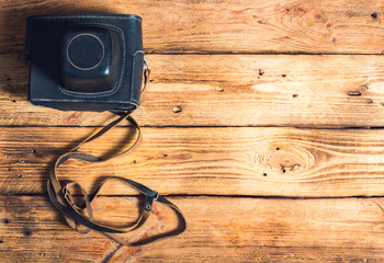old camera in wooden background