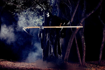 Portrait of grim reaper, the angel of death ( Azrael ) lurking through the woods at night...